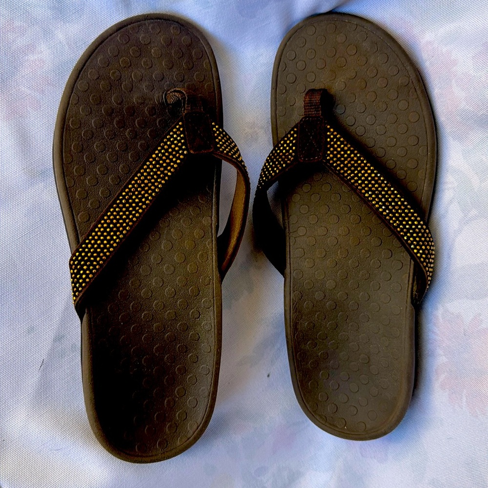 Brown and gold viconic flip flops